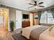 Bedroom featuring hardwood floors, a modern fan, and ample natural light from a large window at 200 Saint Andrews Blvd # 1004, Winter Park, FL 32792