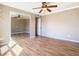 Bright and spacious bedroom featuring laminate floors, ceiling fan, and closet with mirrored doors, allowing natural light at 200 Saint Andrews Blvd # 1004, Winter Park, FL 32792