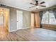 Bedroom with laminate floors, a window with curtains, ceiling fan, and adjacent hallway and doorway adds depth to the space at 200 Saint Andrews Blvd # 1004, Winter Park, FL 32792