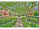 A lush courtyard with mature trees, shrubs, and manicured lawn creates a serene outdoor space at 200 Saint Andrews Blvd # 1004, Winter Park, FL 32792