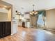 Dining area featuring modern lighting, granite countertops, and new hardwood floors at 200 Saint Andrews Blvd # 1004, Winter Park, FL 32792