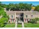 Charming two-story townhouse with red shutters, lush landscaping, and well-maintained lawn at 200 Saint Andrews Blvd # 1004, Winter Park, FL 32792
