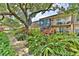 Exterior view of building with mature trees and landscaping at 200 Saint Andrews Blvd # 1004, Winter Park, FL 32792