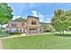 Well-maintained building featuring a manicured lawn and colorful landscaping at 200 Saint Andrews Blvd # 1004, Winter Park, FL 32792