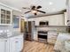 Bright kitchen featuring granite countertops, stainless steel appliances, and classic white cabinets at 200 Saint Andrews Blvd # 1004, Winter Park, FL 32792
