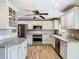 Bright kitchen boasts stainless steel appliances, granite countertops, and sleek white cabinetry at 200 Saint Andrews Blvd # 1004, Winter Park, FL 32792