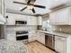 Updated kitchen with stainless steel appliances, granite counters, and custom white cabinets at 200 Saint Andrews Blvd # 1004, Winter Park, FL 32792