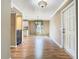 A spacious living area featuring hardwood floors that connect to a modern kitchen at 200 Saint Andrews Blvd # 1004, Winter Park, FL 32792