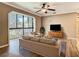 Bright living room with a large window, modern furniture, and hardwood floors at 200 Saint Andrews Blvd # 1004, Winter Park, FL 32792