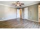 Spacious bedroom featuring laminate floors, neutral colored walls, and doors that add depth to the room at 200 Saint Andrews Blvd # 1004, Winter Park, FL 32792