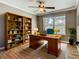 Home office with built-in bookshelves, a large desk, and a comfortable chair at 200 Saint Andrews Blvd # 1004, Winter Park, FL 32792