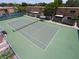 Aerial view of a well-maintained community tennis court surrounded by fencing and landscaping at 200 Saint Andrews Blvd # 1004, Winter Park, FL 32792