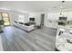 Open-concept living space seamlessly connects the living room and kitchen, featuring modern finishes and wood-look flooring at 2082 Sw 153Rd Loop, Ocala, FL 34473