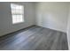 A simple bedroom with hard surface floors and a window providing natural light at 2232 Sw 178Th Lane Rd, Ocala, FL 34473