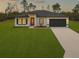 Inviting single-story home with a well-manicured lawn and a modern front facade at 2232 Sw 178Th Lane Rd, Ocala, FL 34473