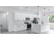 Modern white kitchen featuring stainless steel appliances, quartz countertops, and an island with pendant lighting at 2232 Sw 178Th Lane Rd, Ocala, FL 34473