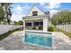 View of the backyard, featuring a covered patio with a bar, outdoor kitchen and a swimming pool at 2408 Lafayette Ave, Winter Park, FL 32789