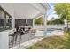 Outdoor living area featuring an outdoor kitchen, bar seating, and a sparkling pool at 2408 Lafayette Ave, Winter Park, FL 32789