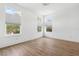 Bright bedroom featuring wood floors, white walls, and large windows with cellular shades at 2408 Lafayette Ave, Winter Park, FL 32789