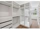Walk-in closet offers custom shelving and hardwood floors with natural light at 2408 Lafayette Ave, Winter Park, FL 32789