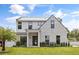 Stunning two-story home with modern architecture, brick accents, manicured lawn, and a sleek metal roof at 2408 Lafayette Ave, Winter Park, FL 32789