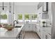 Bright kitchen featuring white cabinetry, a spacious island with seating, and modern appliances at 2408 Lafayette Ave, Winter Park, FL 32789