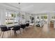 Open-concept living and dining area featuring hardwood floors, modern decor, and ample natural light at 2408 Lafayette Ave, Winter Park, FL 32789