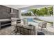 Inviting outdoor living space with a built-in grill, lounge area, and view of the pool at 2408 Lafayette Ave, Winter Park, FL 32789