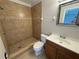 Bathroom featuring tiled walls, a walk-in shower, and a modern vanity at 2431 Lackland Dr, Deltona, FL 32738