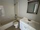 Bright white bathroom with shower-tub, toilet, vanity and an framed mirror at 2431 Lackland Dr, Deltona, FL 32738