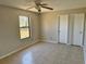 Spacious bedroom with tiled floor, ceiling fan, and ample closet space at 2431 Lackland Dr, Deltona, FL 32738