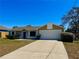 Charming single-story home with a well-maintained lawn and a two-car garage at 2431 Lackland Dr, Deltona, FL 32738
