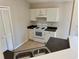 Functional kitchen with white cabinets, laminate counters, and essential appliances at 2431 Lackland Dr, Deltona, FL 32738