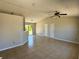 Open-concept living room featuring tiled floor and neutral paint scheme at 2431 Lackland Dr, Deltona, FL 32738