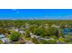 An aerial view of a neighborhood with a lake, trees, and blue skies at 2501 Weber St, Orlando, FL 32803