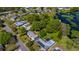 An aerial view shows the neighborhood's houses, green trees and lake at 2501 Weber St, Orlando, FL 32803