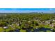 An aerial view features homes, trees and a lake in a neighborhood community at 2501 Weber St, Orlando, FL 32803