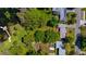 A top-down aerial view of homes with lake access and lush greenery at 2501 Weber St, Orlando, FL 32803