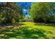 A spacious, lush green backyard with mature trees, offering shade and privacy at 2501 Weber St, Orlando, FL 32803