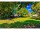 Lush backyard with mature trees offers a private and serene outdoor experience at 2501 Weber St, Orlando, FL 32803