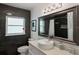 Modern bathroom with unique dark tile, stylish fixtures, and ample natural light at 2501 Weber St, Orlando, FL 32803