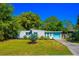 Charming single-story home with a well-manicured lawn and a vibrant turquoise garage door at 2501 Weber St, Orlando, FL 32803