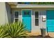 Inviting turquoise front door with sidelights, enhancing curb appeal and charm at 2501 Weber St, Orlando, FL 32803