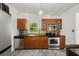 Well-lit kitchen with stainless steel appliances, wood cabinetry, and a view to the outdoors at 2501 Weber St, Orlando, FL 32803
