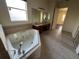 Bathroom with corner tub, dual sinks, and neutral tile flooring for a relaxing space at 2715 Bartlet Dr, Kissimmee, FL 34741