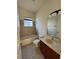 Bathroom showcasing tiled walls around the tub and shower, and a vanity with great lighting at 2715 Bartlet Dr, Kissimmee, FL 34741