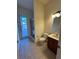 Bathroom with a shower and access door to the outdoor pool, with modern sink and fixtures at 2715 Bartlet Dr, Kissimmee, FL 34741