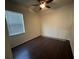 Bedroom featuring hardwood floors, ceiling fan and window with blinds to provide natural light at 2715 Bartlet Dr, Kissimmee, FL 34741