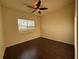 Bedroom featuring hardwood floors, a ceiling fan, and a window bringing in natural light at 2715 Bartlet Dr, Kissimmee, FL 34741