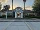 Community clubhouse features a tile roof, an arched entrance and plenty of parking at 2715 Bartlet Dr, Kissimmee, FL 34741